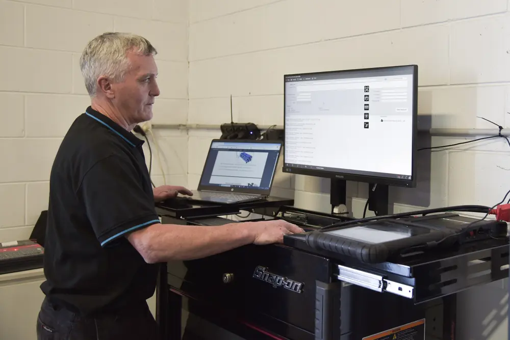 Mechanic using a workshop diagnostic workstation