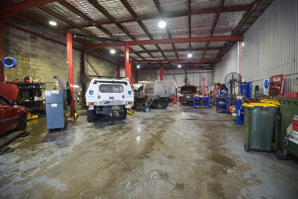 Advanced Automotive Services workshop interior with vehicles in service bays