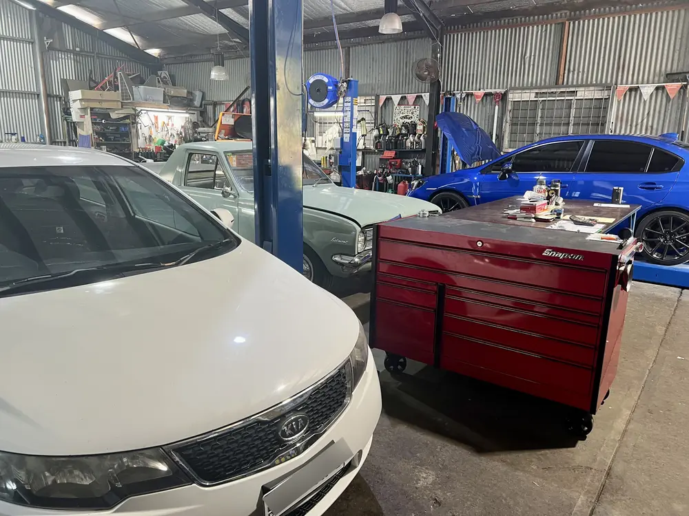 Vehicles and workshop equipment inside the Advanced Automotive Services workshop